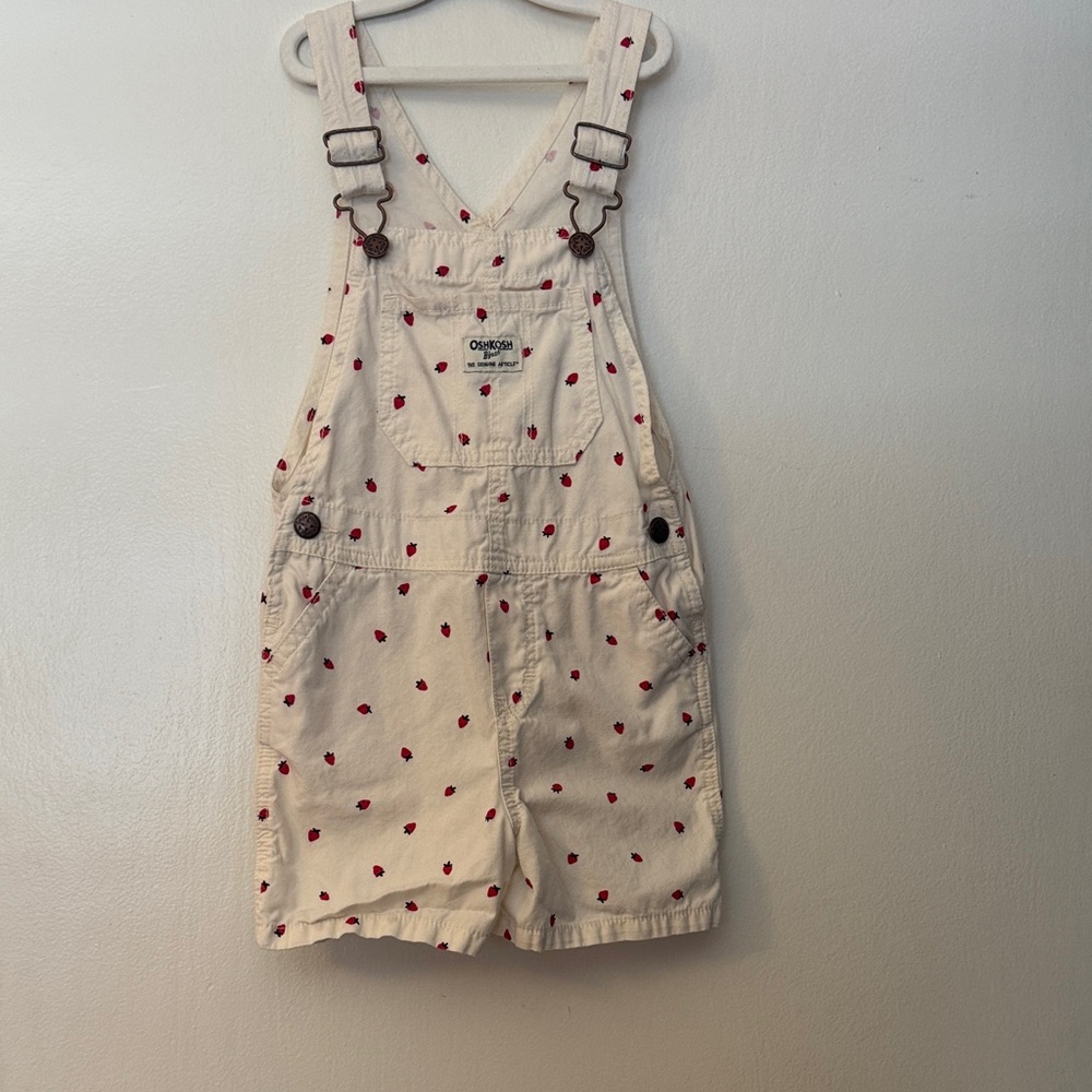 OshKosh B'gosh off white overalls with strawberries.
